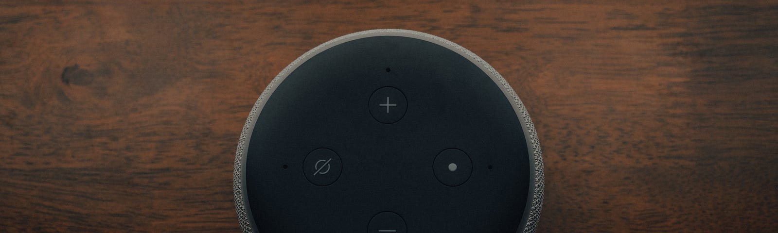 A photo of an amazon echo device as seen from the top.