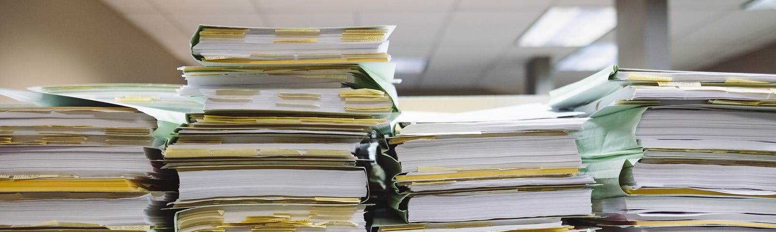 Stacks of paper and file folders on a table