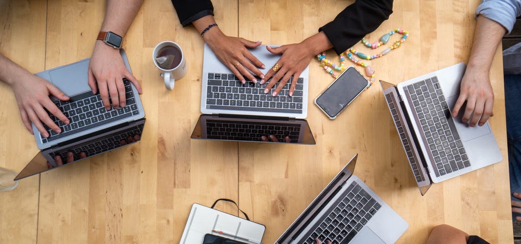 four laptops on a table