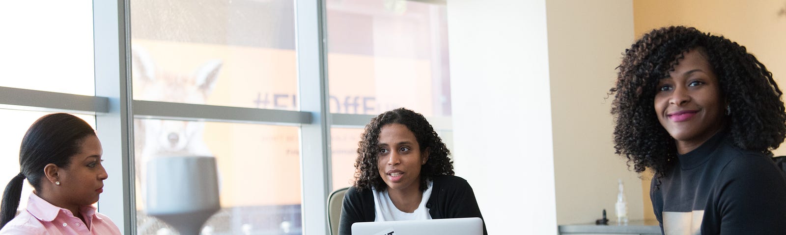 Three women in a meeting at work.