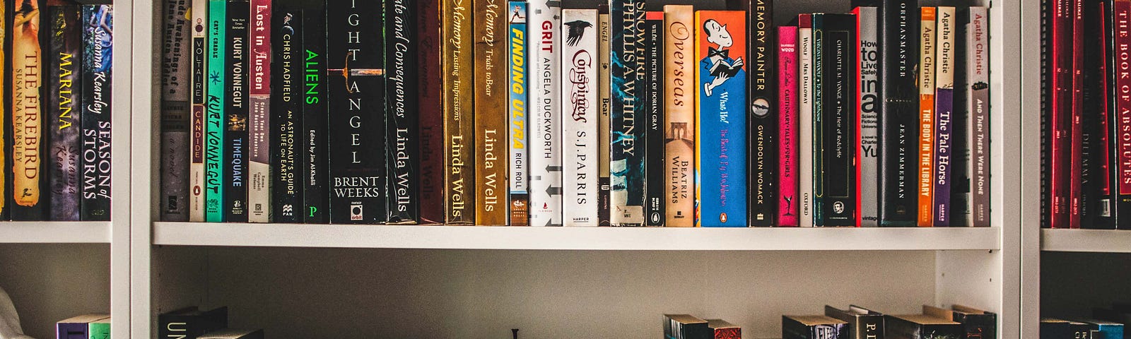 colorful bookshelf with ceramic bowl and lots of books