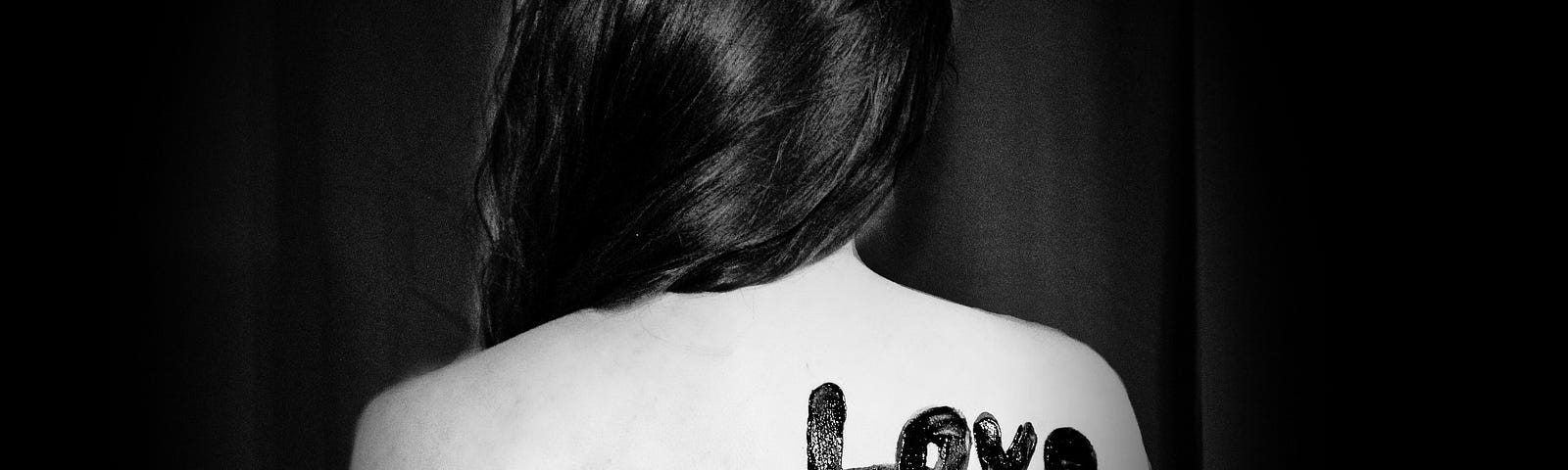 picture of a child’s back with the inscription of “love shouldn’t hurt”