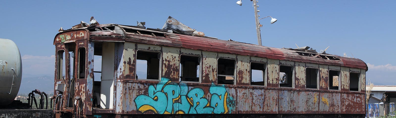 Photo of an old abandoned train car with graffiti