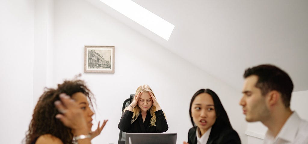 three ladies and a man in a conflict resolution meeting