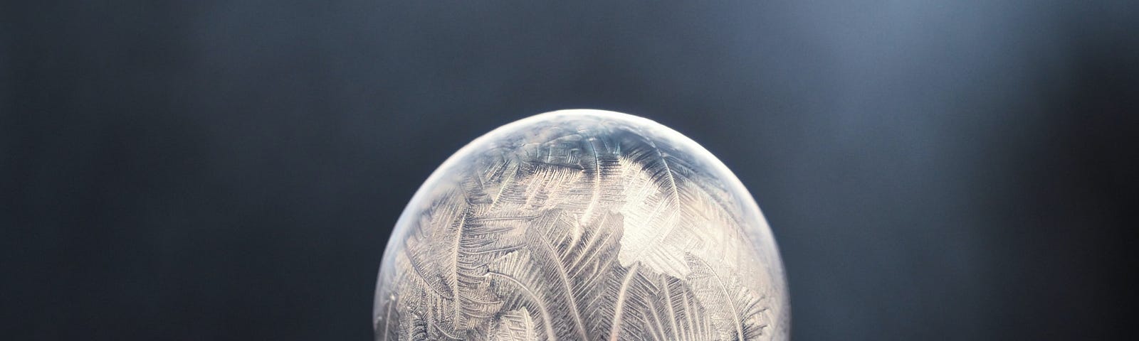 A frozen bubble creates a ball of crystals on frozen snow.