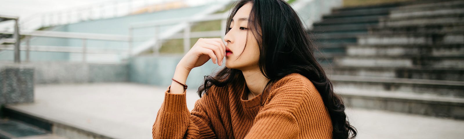 girl sitting on stairs in thought