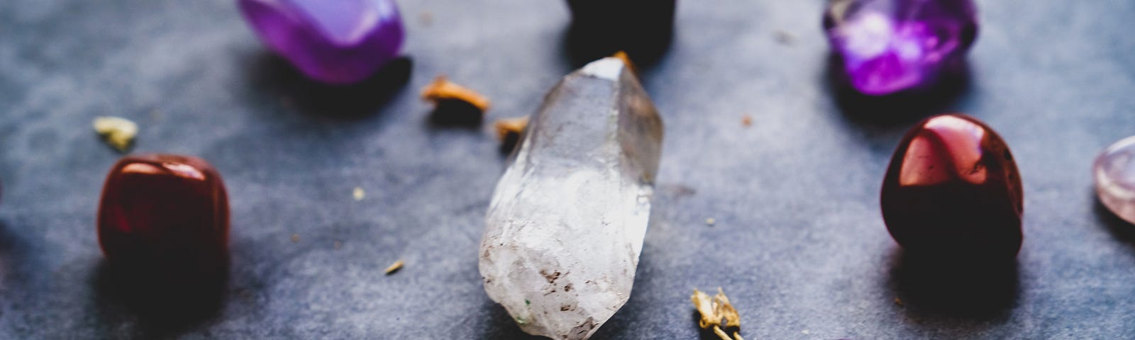 A collection of purple gemstones with one white one in the middle