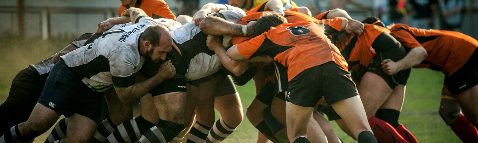 rugby players grappling together for the ball