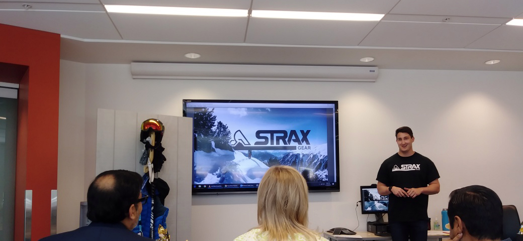 Strax Gear presents their company with a presentation and examples of their products to three judges.