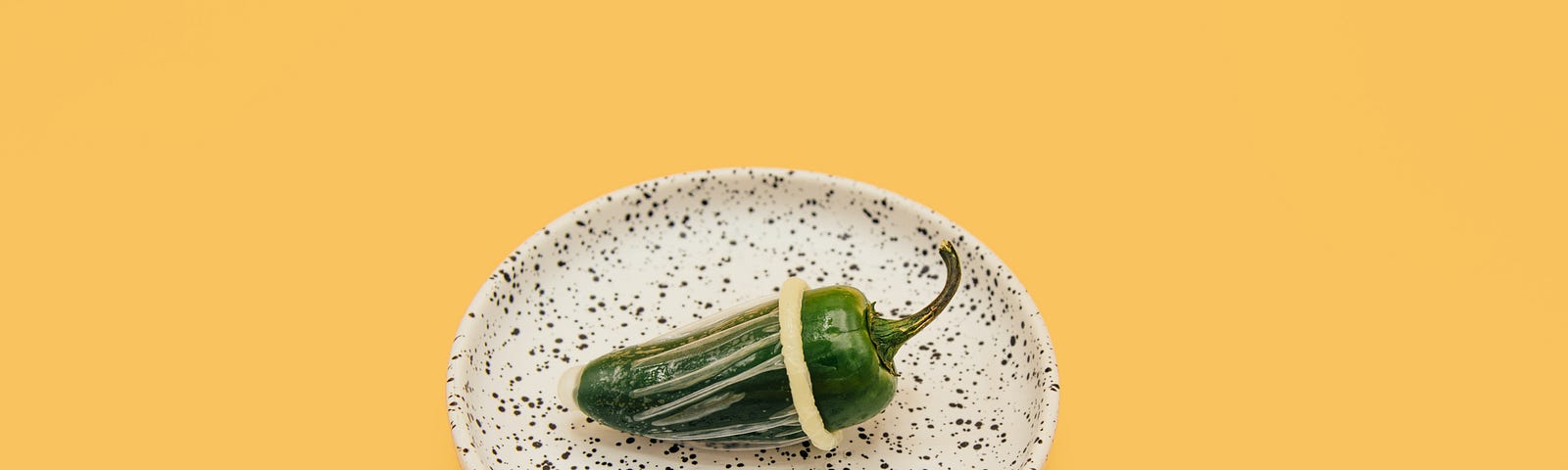 A jalapeno with a condom on it