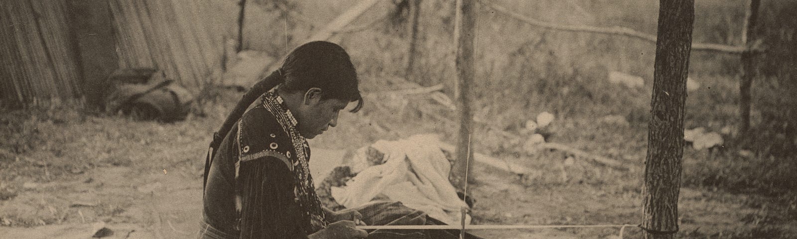 Navajo woman working on a blanket