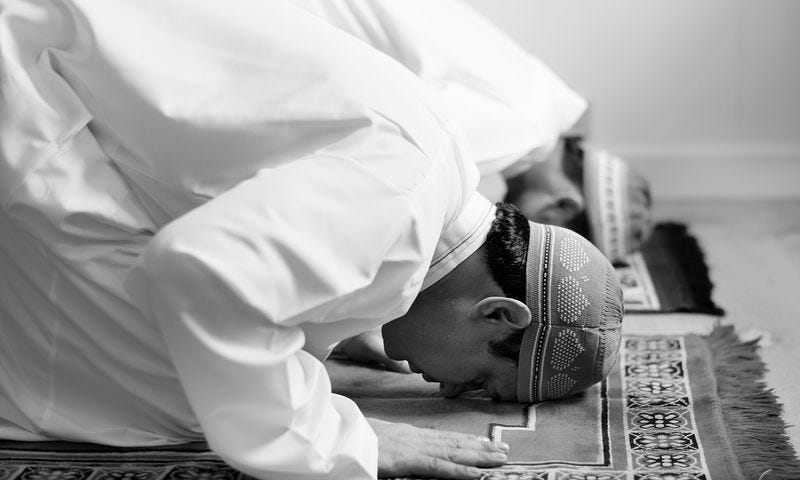 Muslims prostrating in prayer