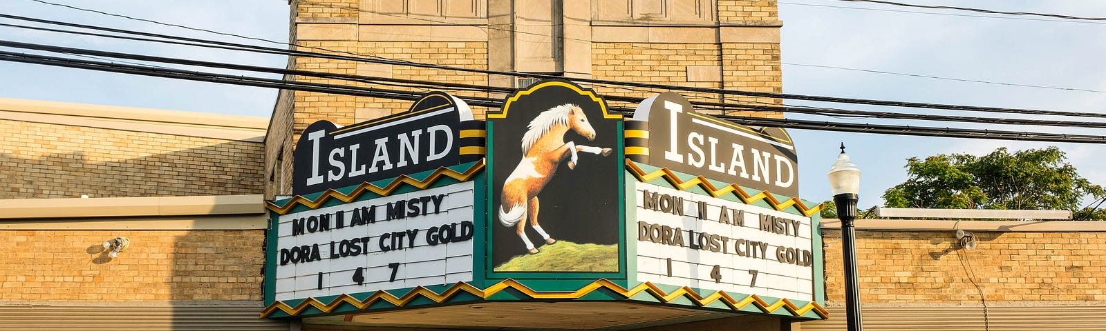 The Island, an old fashion movie house marquee touting a movie, once a scene for hoards of kids on Saturday mornings.
