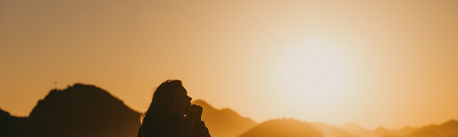 A woman sitting on the seashore in a contemplative mood