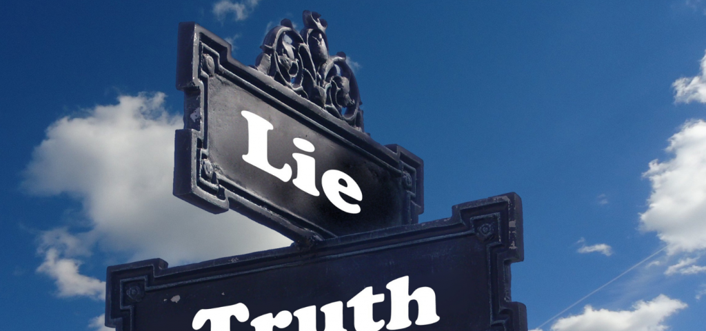 Street signs showing the crossroads of “lie” and “truth”.