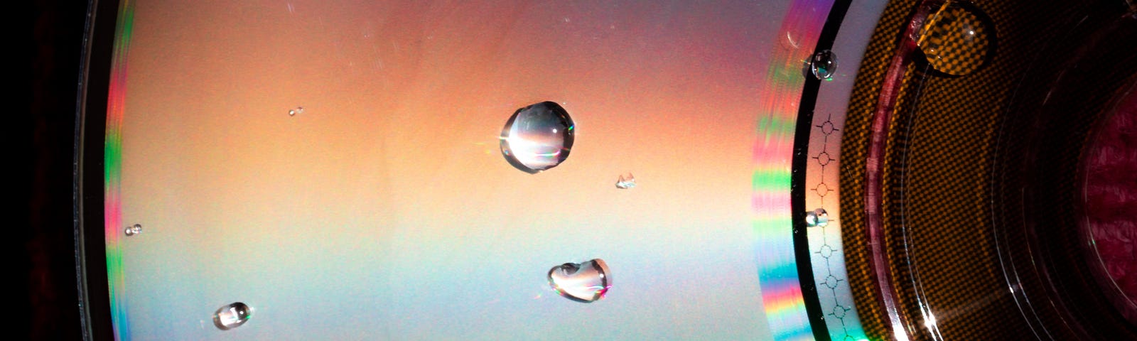 close up of compact disc with beads of water on it