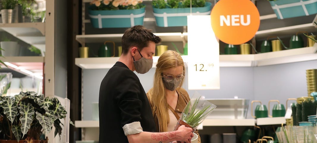 Two people shop for plants at Ikea.