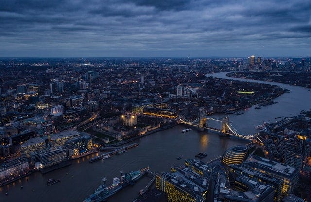Aerial photograph of London at dusk, with the Thames, Tower Bridge and central London