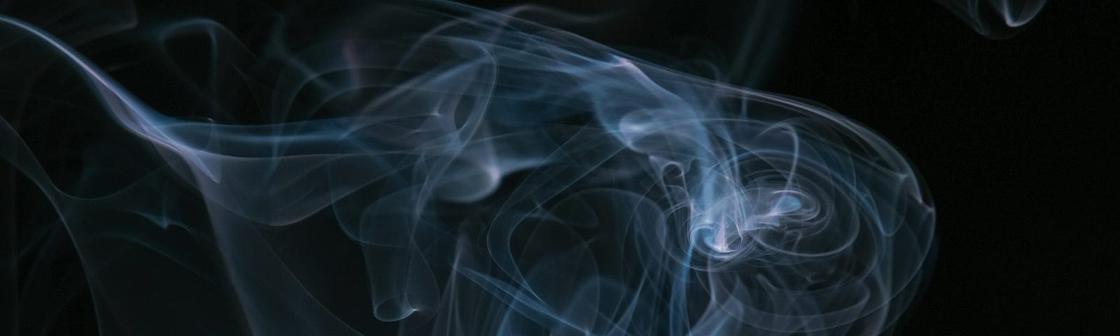 Wisps of rising blue-white smoke front a black background.