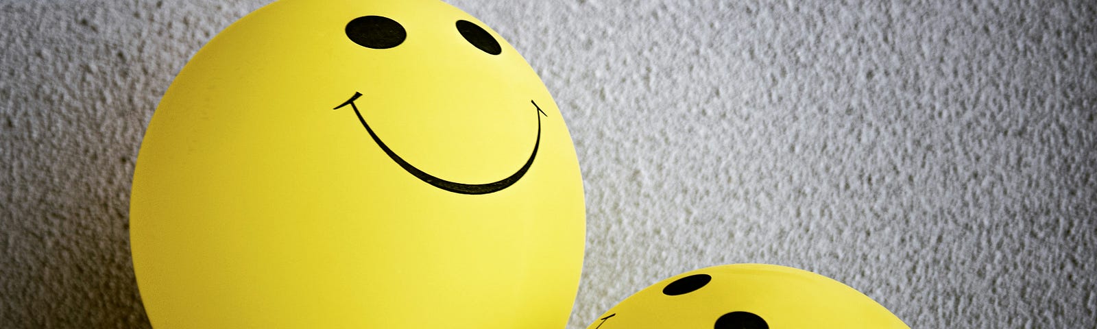 baloons with smiling yellow faces