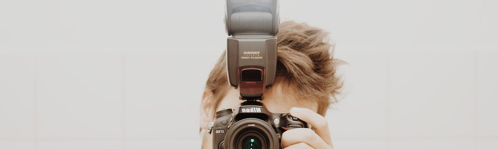 guy holding digital camera in front of his face