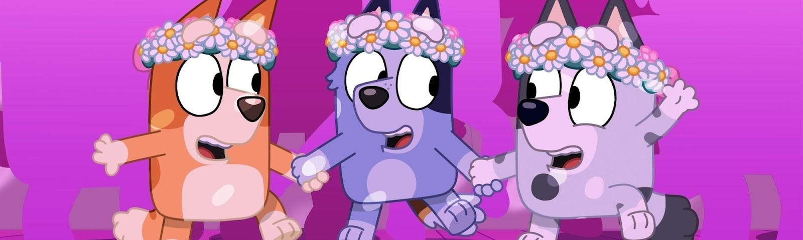 Cartoon image of orange dog, blue dog, and gray dog toddlers dancing in flower crowns, from the show Bluey.