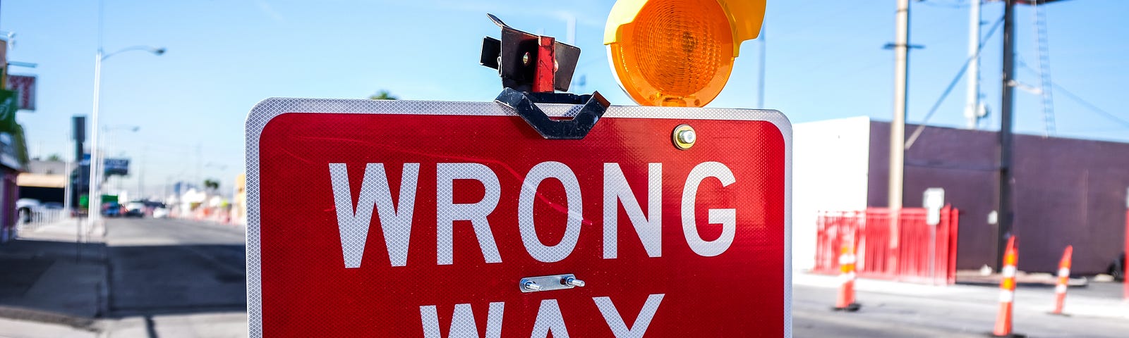 Sign on a street stating Wrong Way