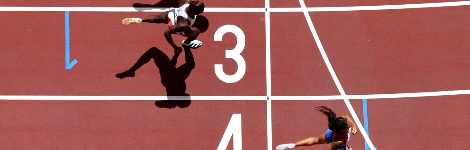 A overhead picture of sprinters crossing a finish line