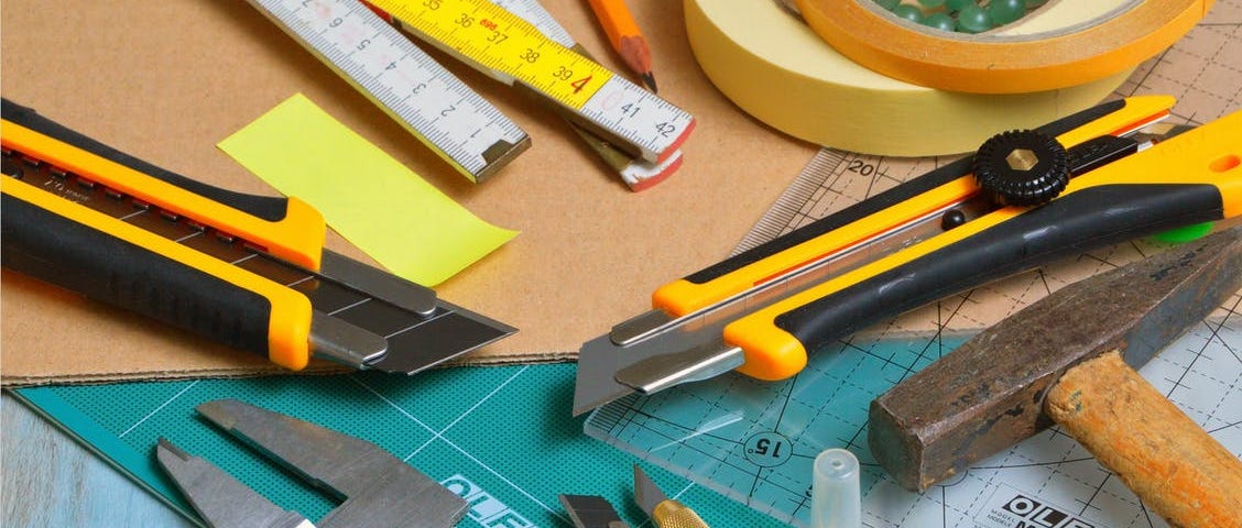 Image of a variety of tools for measuring, cutting, drawing