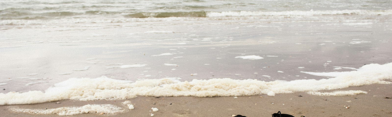 A pair of boots on a beach