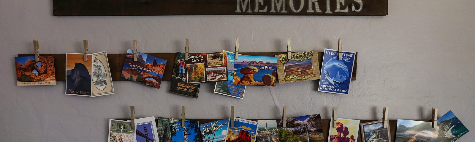 Display of photographs hanging by clothes pin clips under a sign that says Miles of Memories.