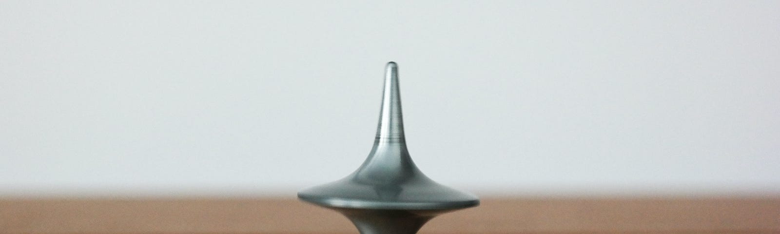 A spinning top balanced on its tip.