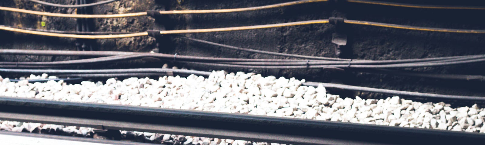 The edge of a train platform. It says mind the gap in yellow lettering.