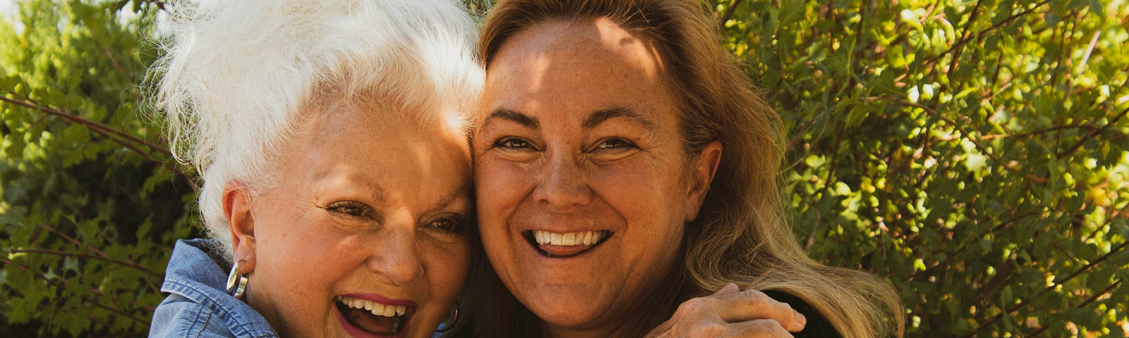 Image of two women, one older and one younger, both looking happy
