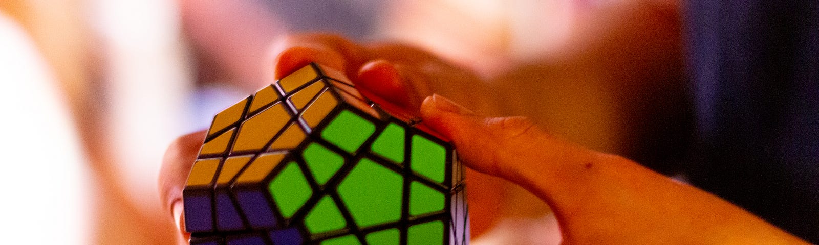 An individual solving a rubik’s cube that looks quite complicated.