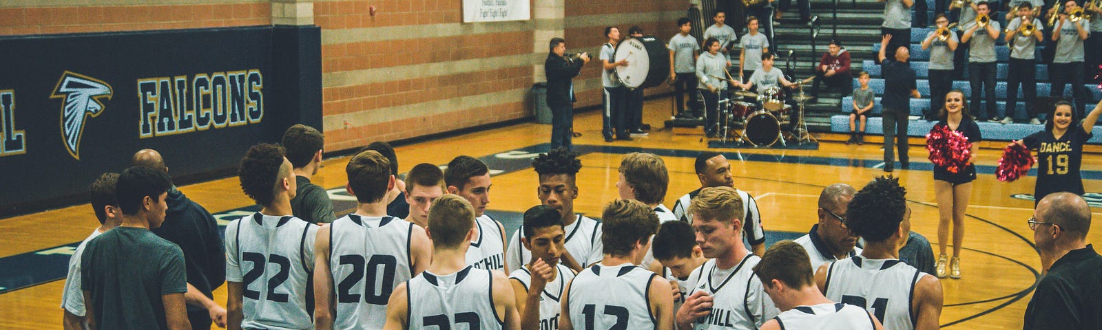 This photo features a young basketball team huddled together.