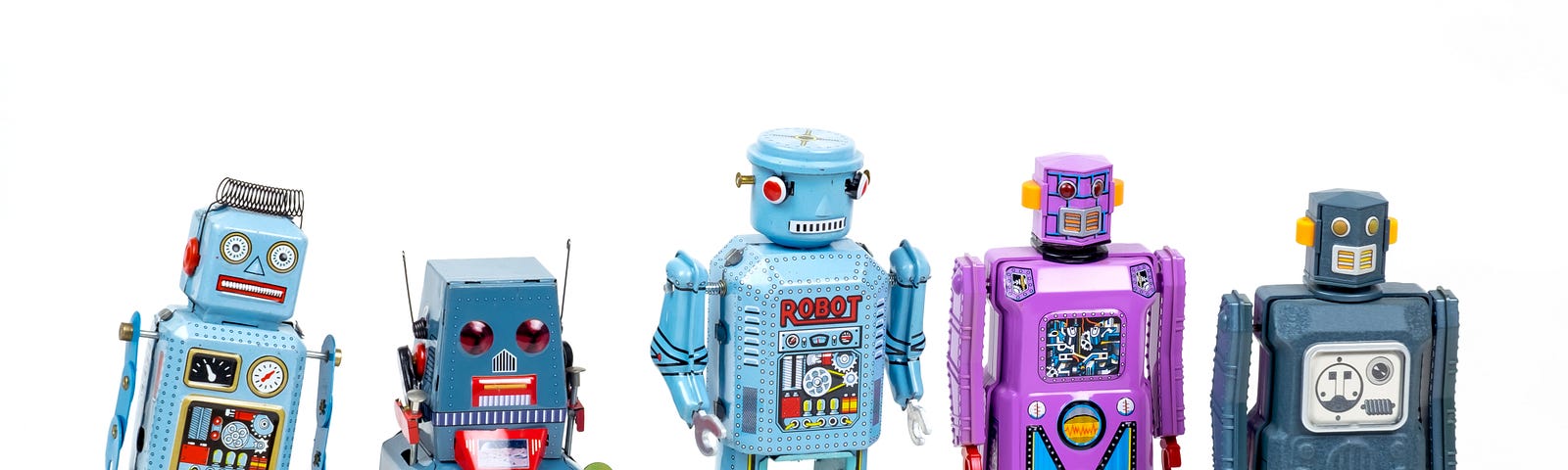 Small robot toys in a line, on a white bacckground, looking stylized and cartoonish in colors ranging from blue-gray to purple