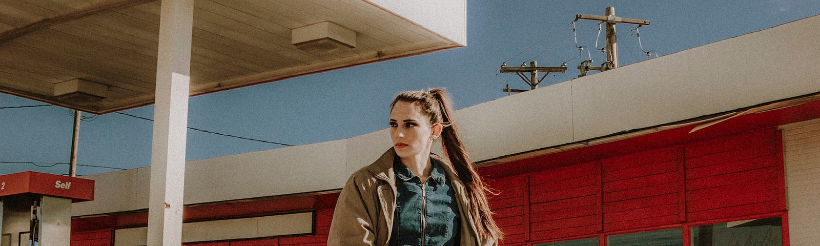 Girl posing in front of red ferrari