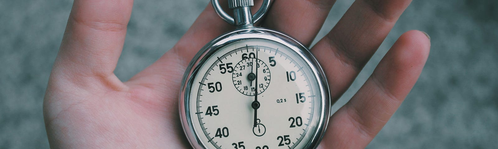 hand holding silver stopwatch