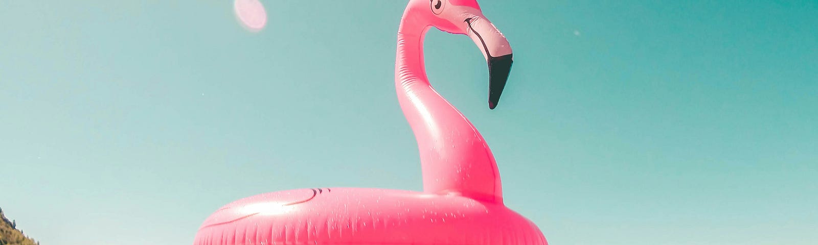 A blowup flamingo floating in the water.