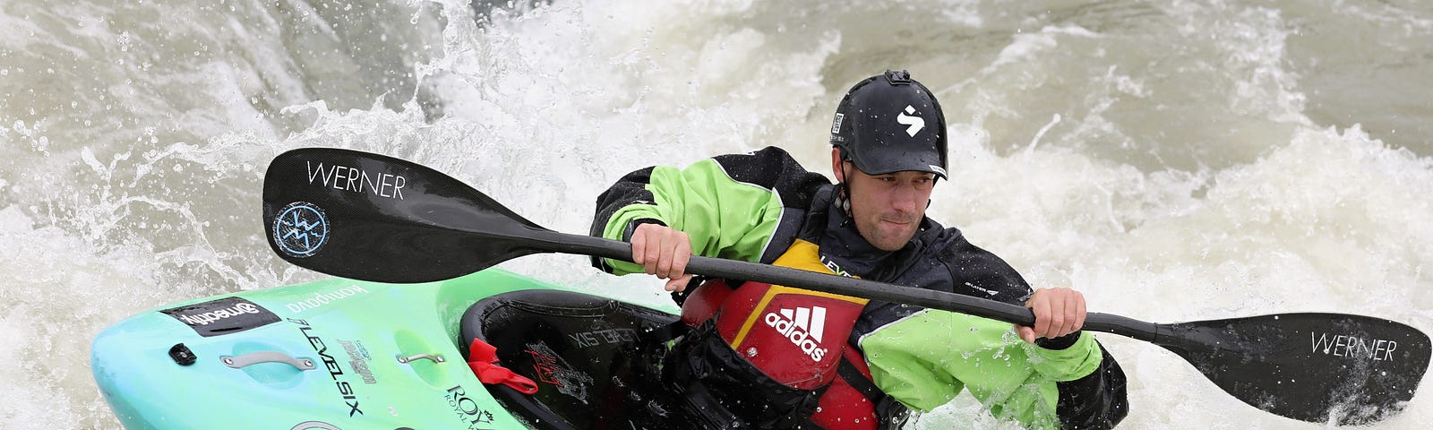 man navigating rapids in a kayak
