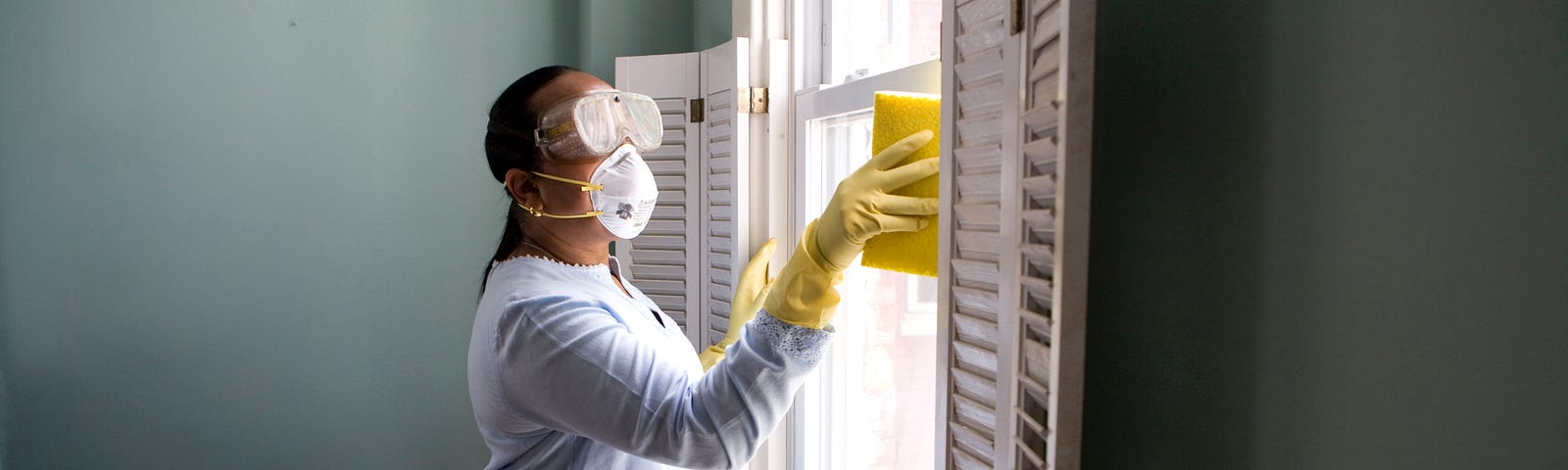 woman sanitizing room