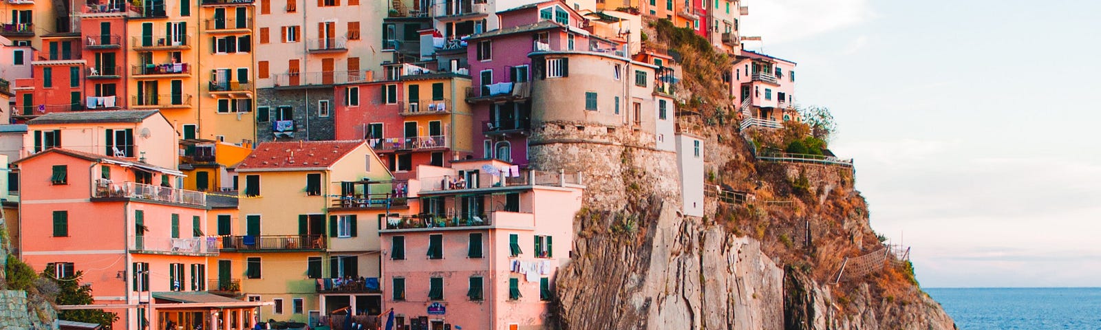 Colorful houses built on a town on top of a hill.
