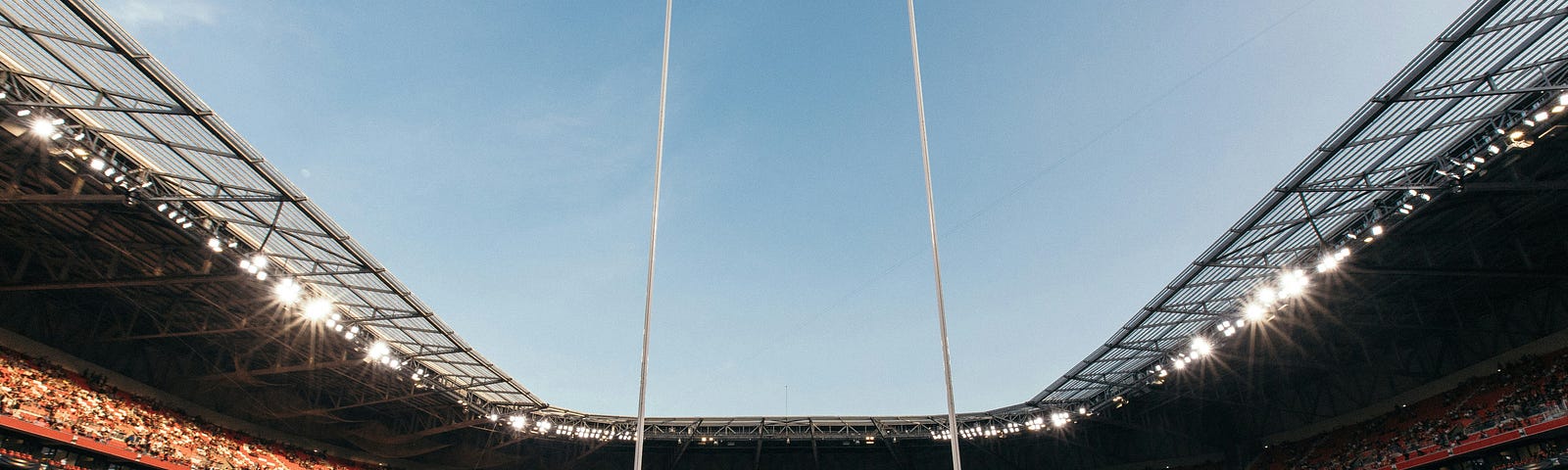 Photo of a rugby field with a full stadium.