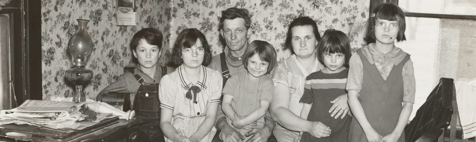 a husband and wife with five children, a black and white photo from perhaps the 1950s
