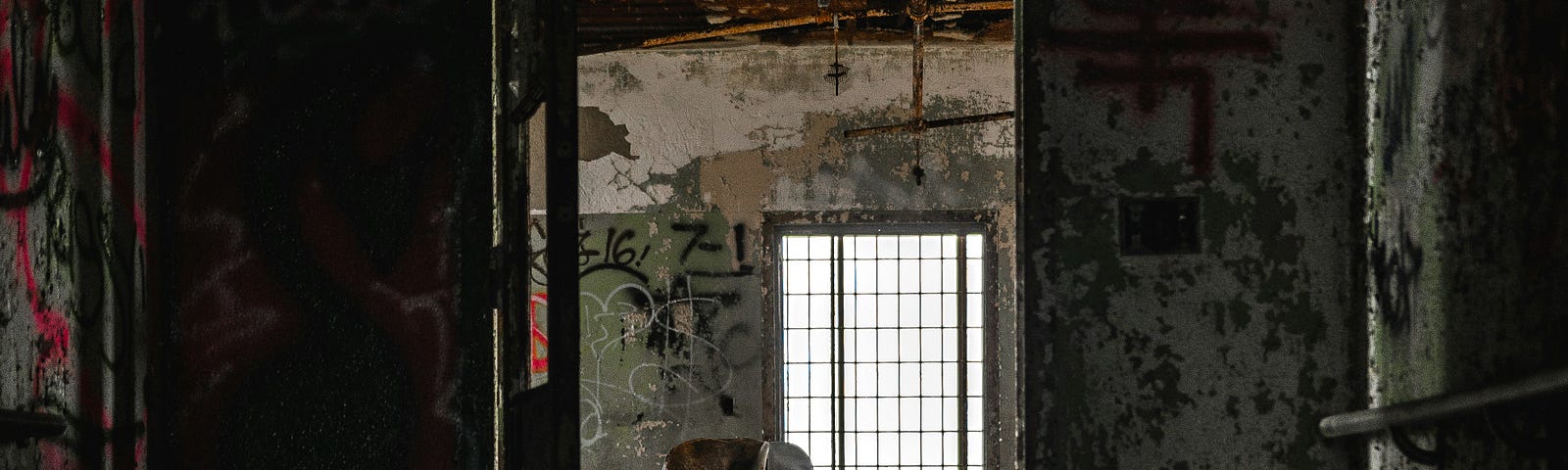 An old house with just a chair. you can see paint chipping off the walls