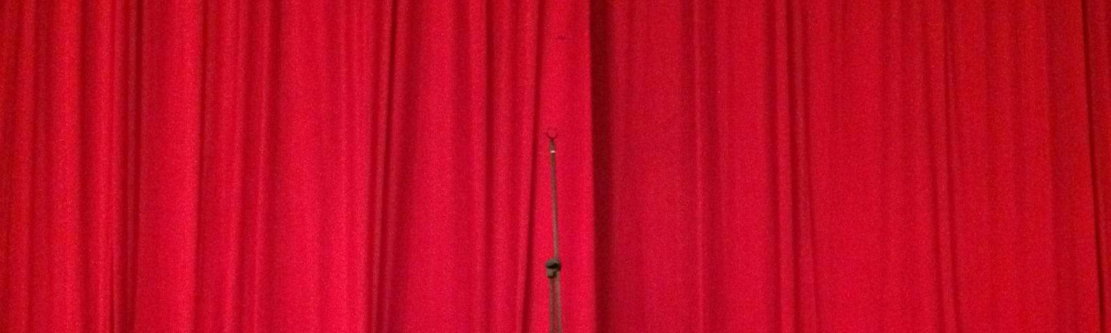 Red curtain on a stage.
