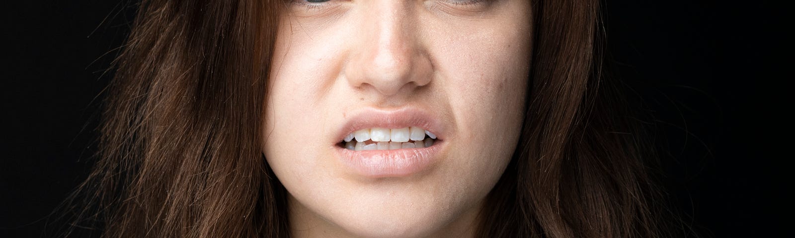 We have a picture of a young woman reacting to a backhanded compliment.