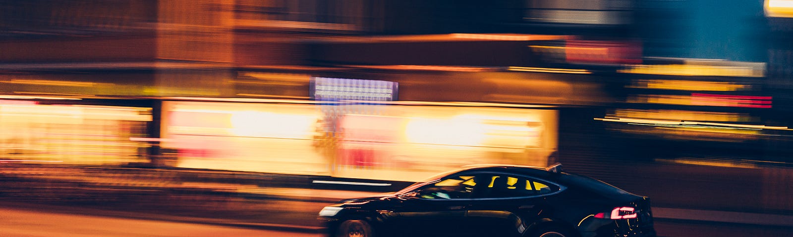 A car driving at a fast speed with background blurred