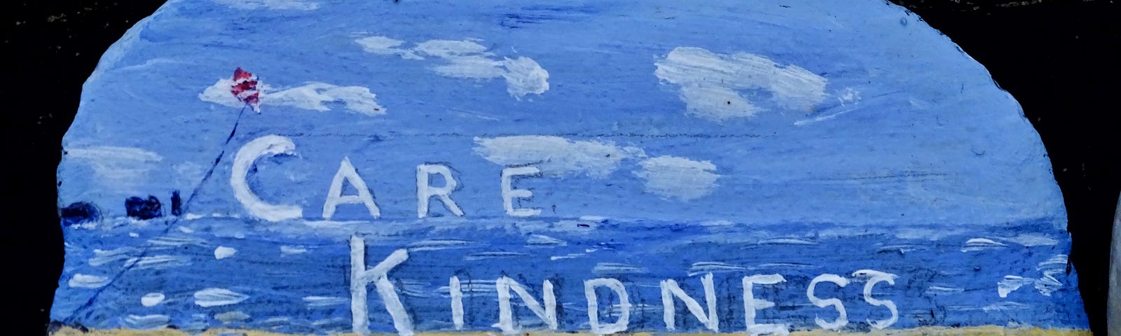 care, kindness, consider painted on a rock